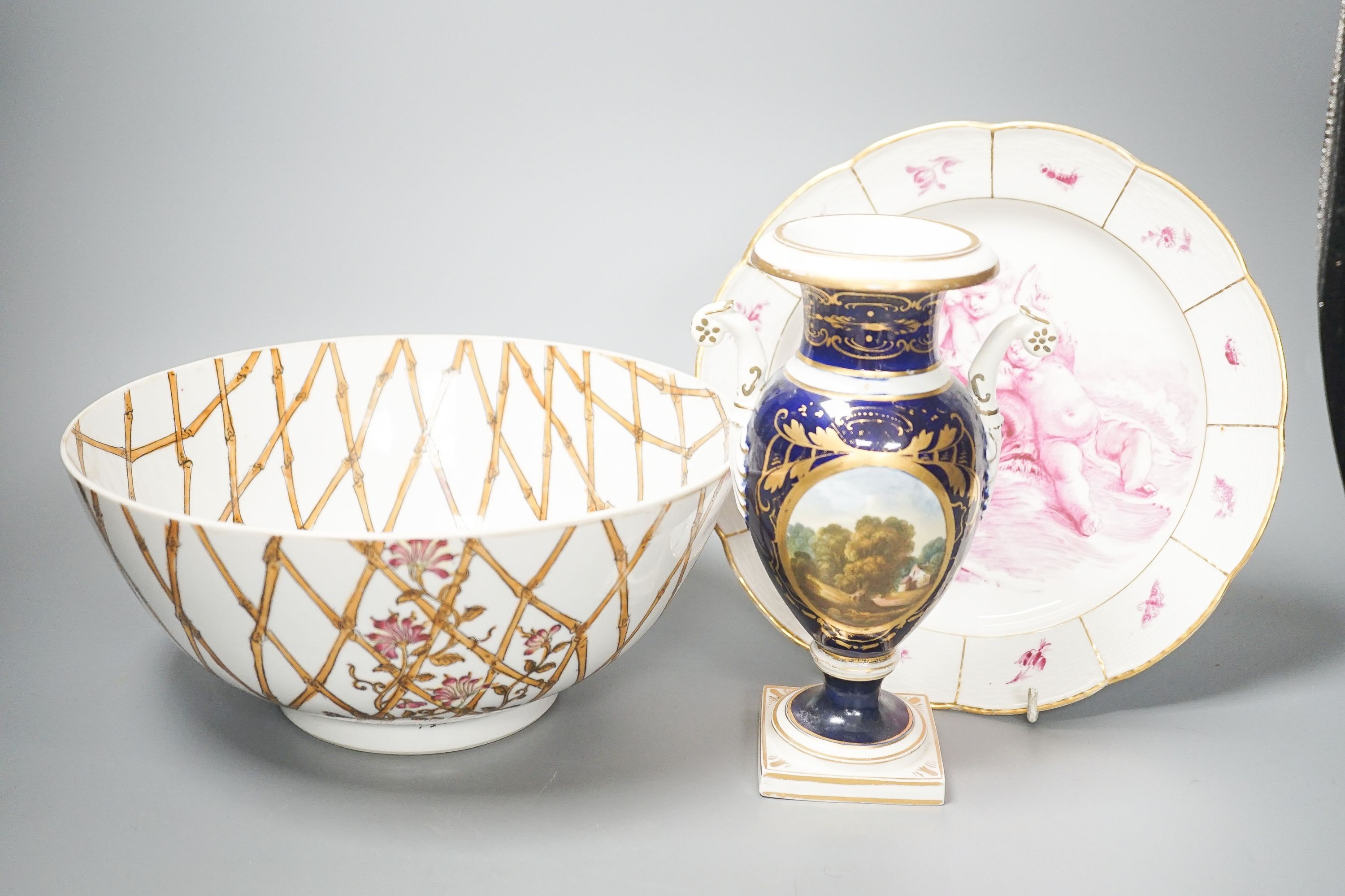 A Furstenburg dessert plate, later painted in puce, signed in reverse ‘W Munscher Stuttgart 1875’, 14.75cm an early 19th century Derby vase and a chinoiserie porcelain bowl (3)